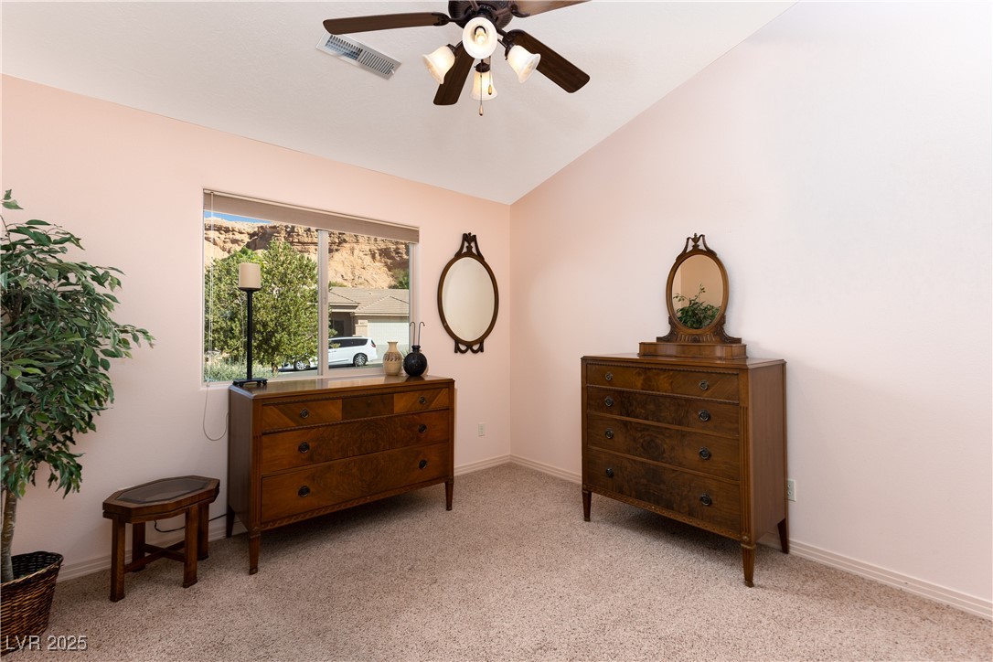 844 Sagedell Road Mesquite, NV 89027 - Photo 12 of 19 Living area featuring vaulted ceiling, light carpet, and ceiling fan