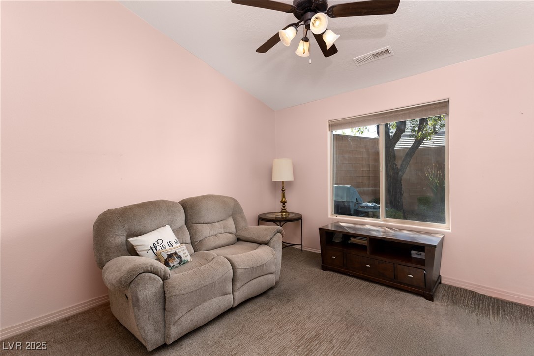 844 Sagedell Road Mesquite, NV 89027 - Photo 13 of 19 Living area with carpet, vaulted ceiling, and a ceiling fan