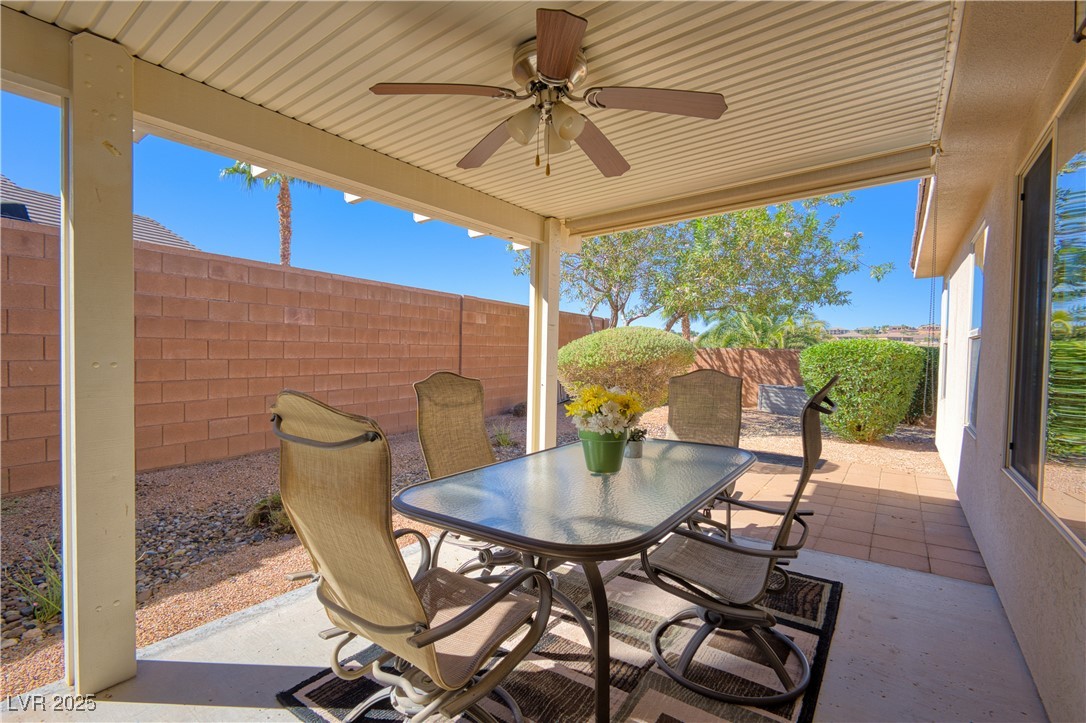 844 Sagedell Road Mesquite, NV 89027 - Photo 3 of 19 Fenced backyard featuring a patio area, outdoor dining area, and ceiling fan