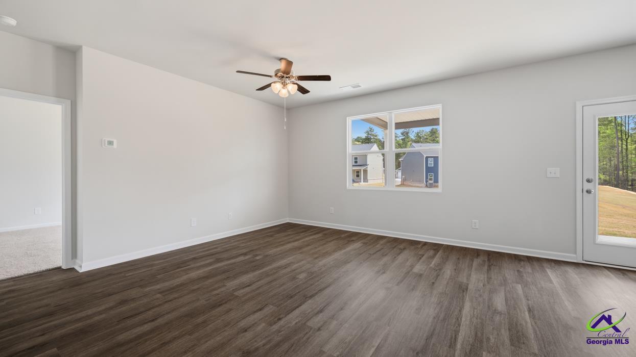 227 Cattle Drive Perry, GA 31069 - Photo 26 of 40 a view of an empty room with wooden floor and a window