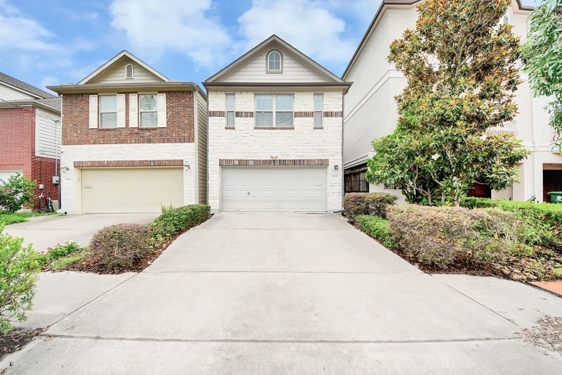 4222 Drake Street Houston, TX 77005 - Photo 2 of 28 a front view of a house with a yard and garage
