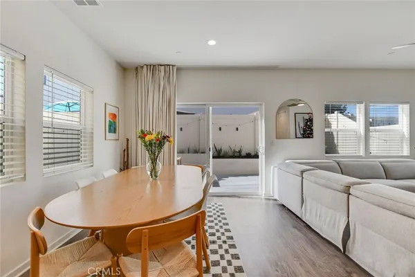 a living room with furniture a flat screen tv and a table