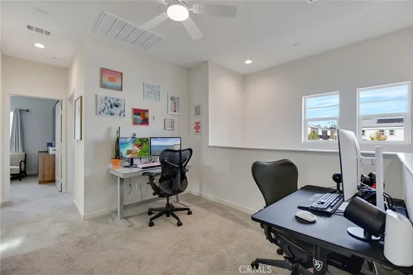a living room with furniture and a painting on the wall