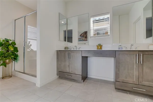 a bedroom with a large bed and a flat tv screen on dresser