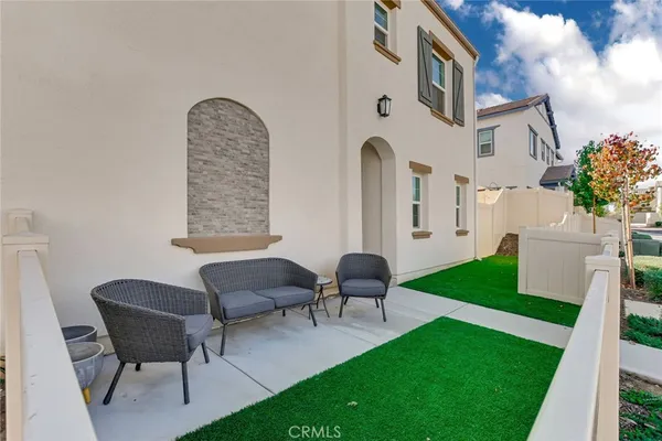 a backyard of a house with table and chairs