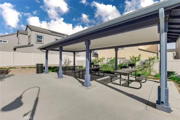 a view of a house with large windows and outdoor space