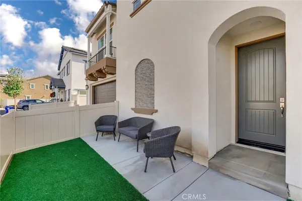 a backyard of a house with table and chairs