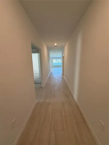 a large kitchen with stainless steel appliances a large counter top a stove a sink and a refrigerator