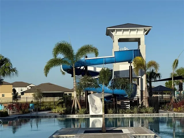 a view of a swimming pool with outdoor seating