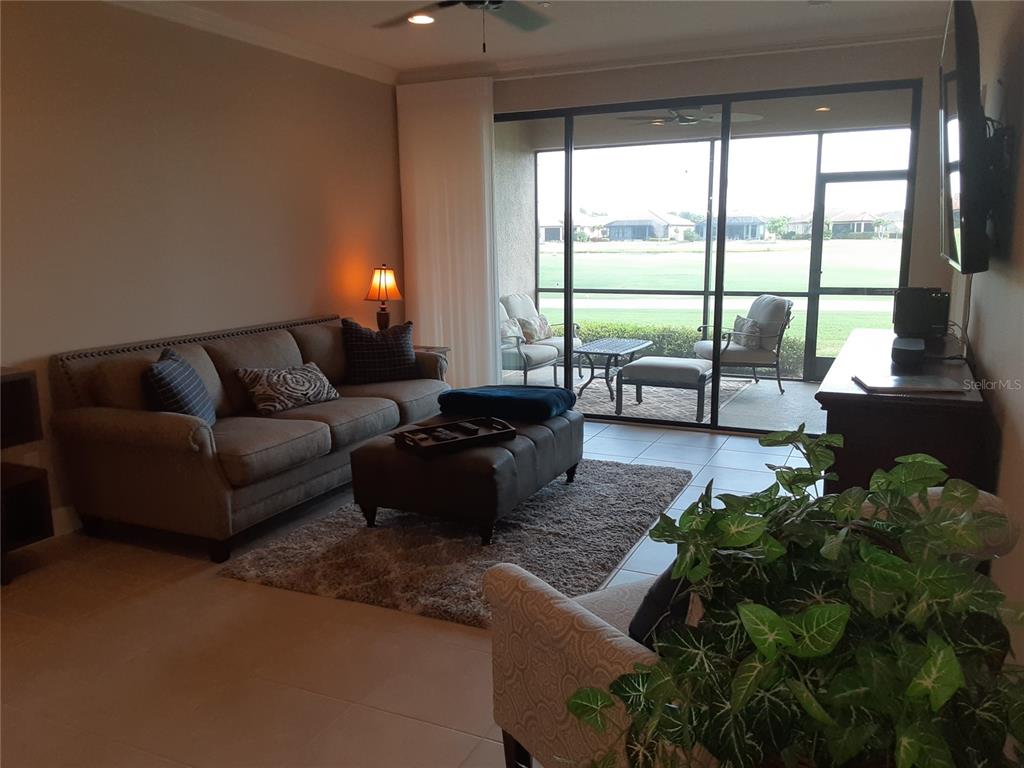 13605 Messina Loop, Unit 104 Bradenton, FL 34211 - Photo 12 of 38 a living room with furniture and a large window