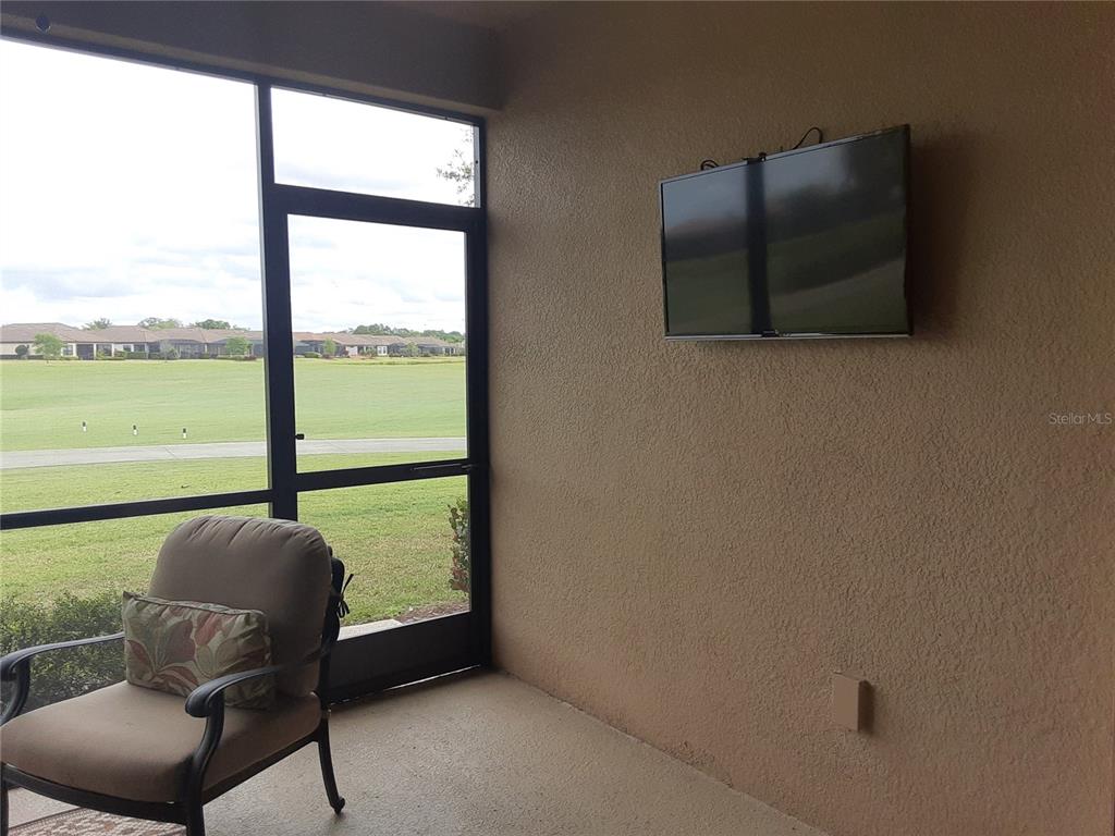 13605 Messina Loop, Unit 104 Bradenton, FL 34211 - Photo 14 of 38 a living room with furniture and a floor to ceiling window
