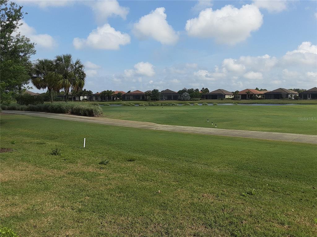 13605 Messina Loop, Unit 104 Bradenton, FL 34211 - Photo 15 of 38 a view of a lake in front of lake and houses