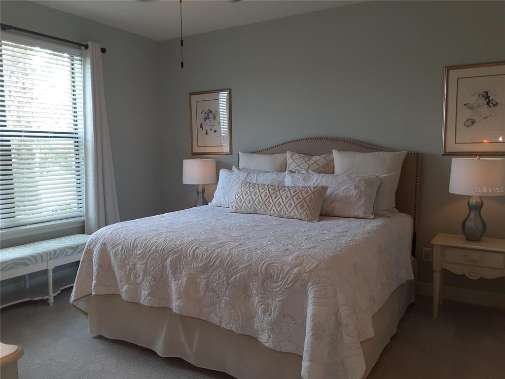 13605 Messina Loop, Unit 104 Bradenton, FL 34211 - Photo 18 of 38 a bedroom with a bed and a lamp on table