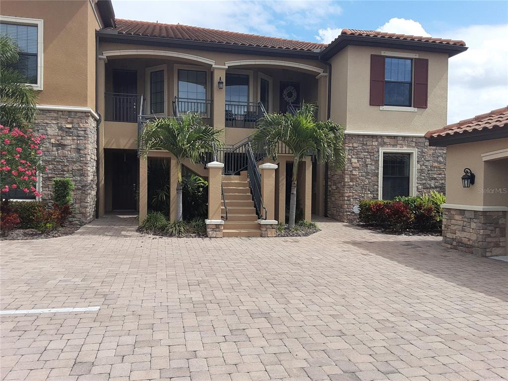13605 Messina Loop, Unit 104 Bradenton, FL 34211 - Photo 2 of 38 a house with palm tree in front of it