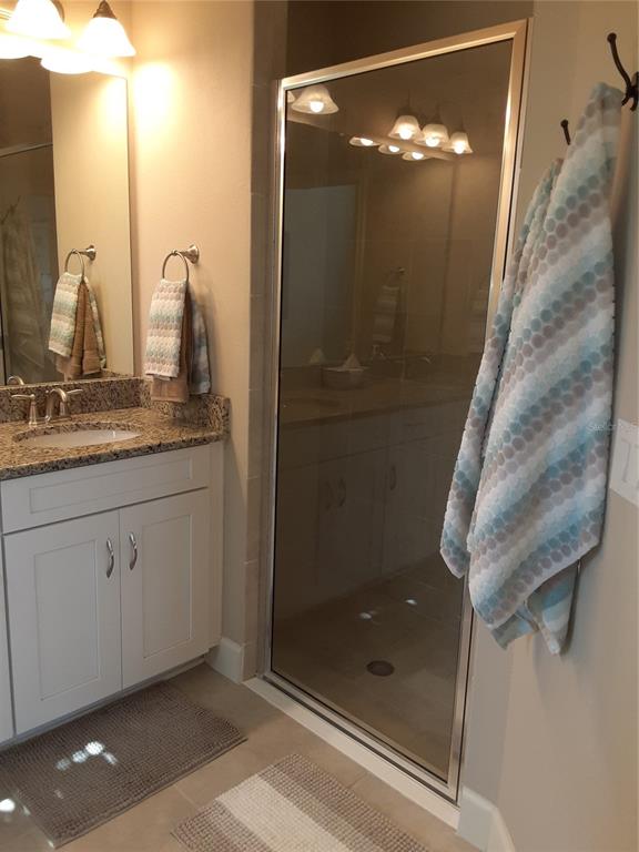 13605 Messina Loop, Unit 104 Bradenton, FL 34211 - Photo 21 of 38 a bathroom with a shower sink and mirror