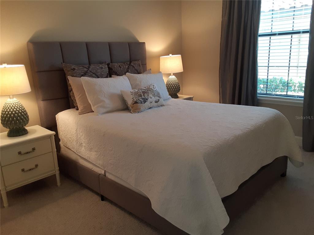 13605 Messina Loop, Unit 104 Bradenton, FL 34211 - Photo 22 of 38 a bed sitting in a bedroom next to a window