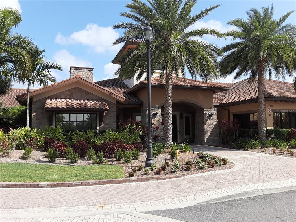 13605 Messina Loop, Unit 104 Bradenton, FL 34211 - Photo 29 of 38 a front view of house with yard and green space