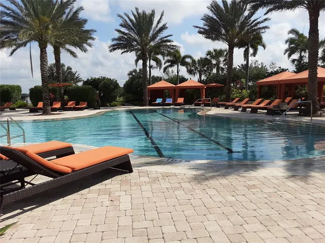 a view of a lake with couches and swimming pool