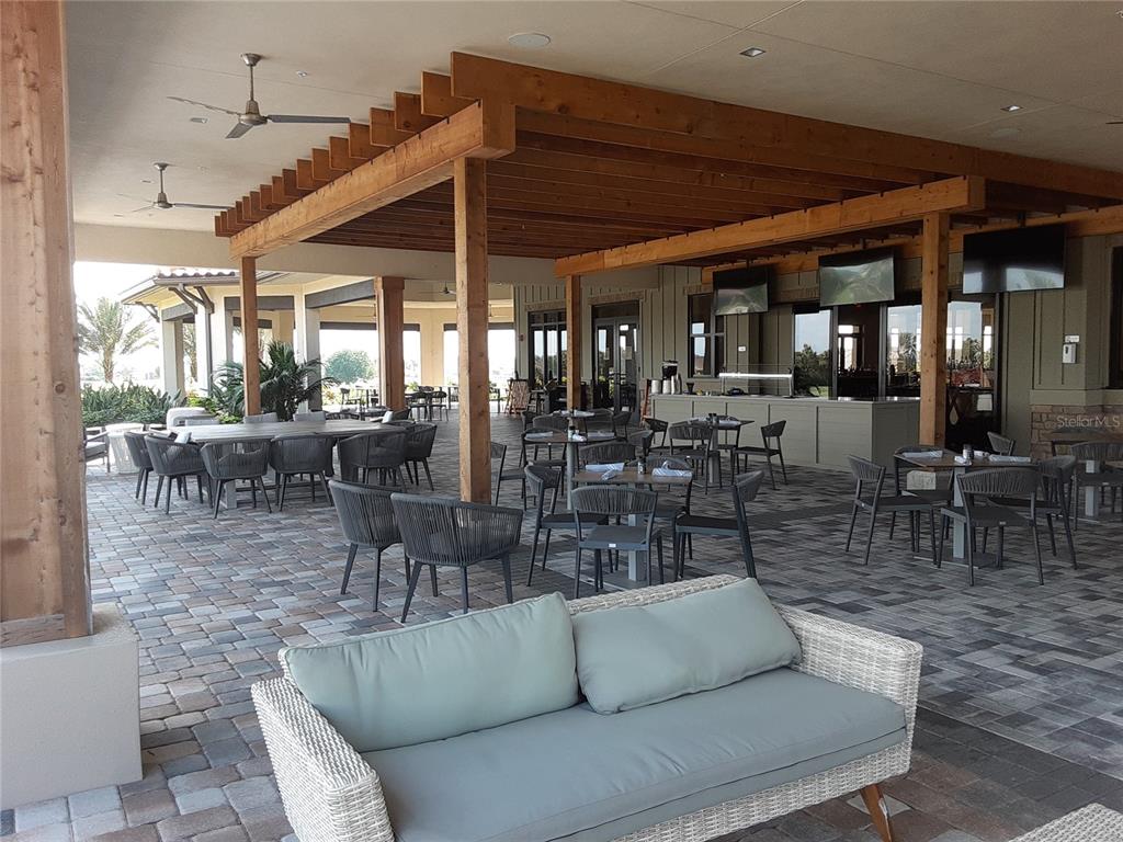 13605 Messina Loop, Unit 104 Bradenton, FL 34211 - Photo 36 of 38 a dining room with lots of tables and chairs
