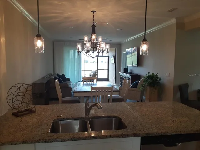 a kitchen with a sink and chandelier