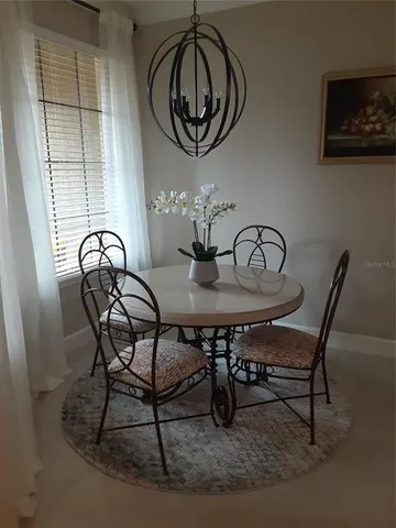 a view of a dining room with furniture and front door