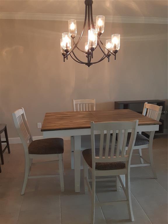 13605 Messina Loop, Unit 104 Bradenton, FL 34211 - Photo 10 of 38 a view of a dining room with furniture and chandelier