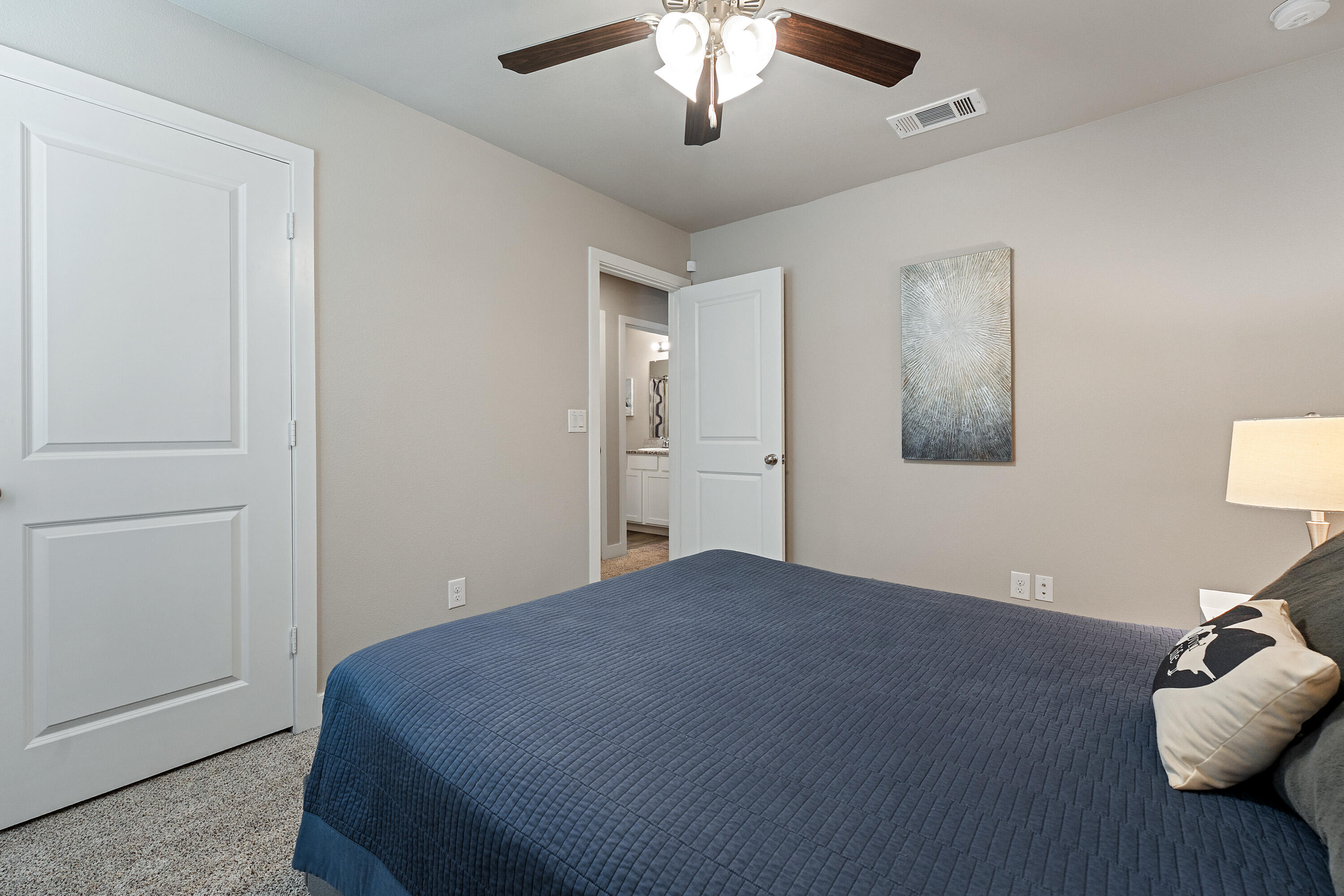 3103 Urbana Avenue Lubbock, TX 79407 - Photo 12 of 19 a bedroom with a bed and a lamp on dresser