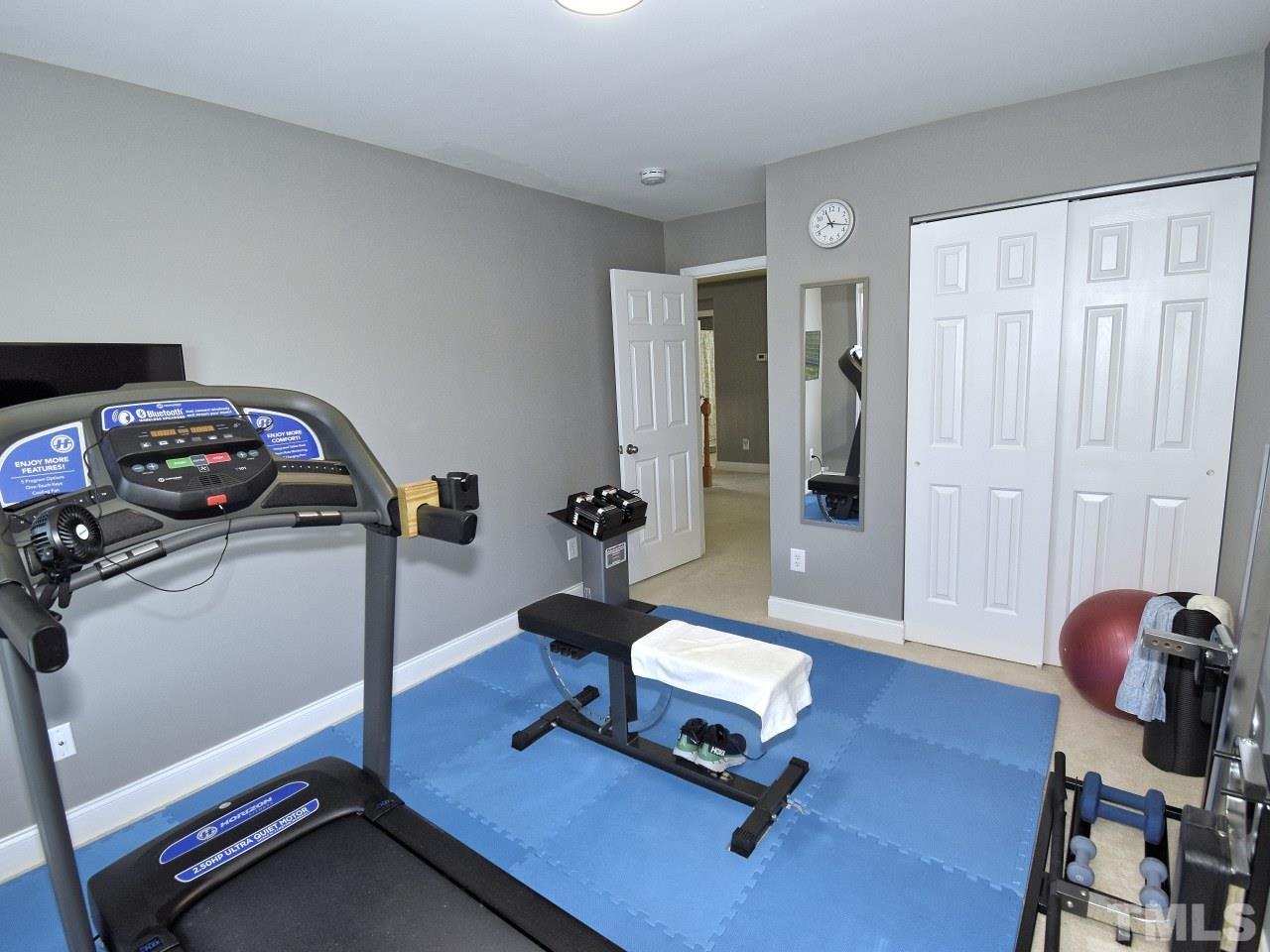 112 Poppy Hills Court Raleigh, NC 27603 - Photo 29 of 42 a view of a workspace with gym equipment