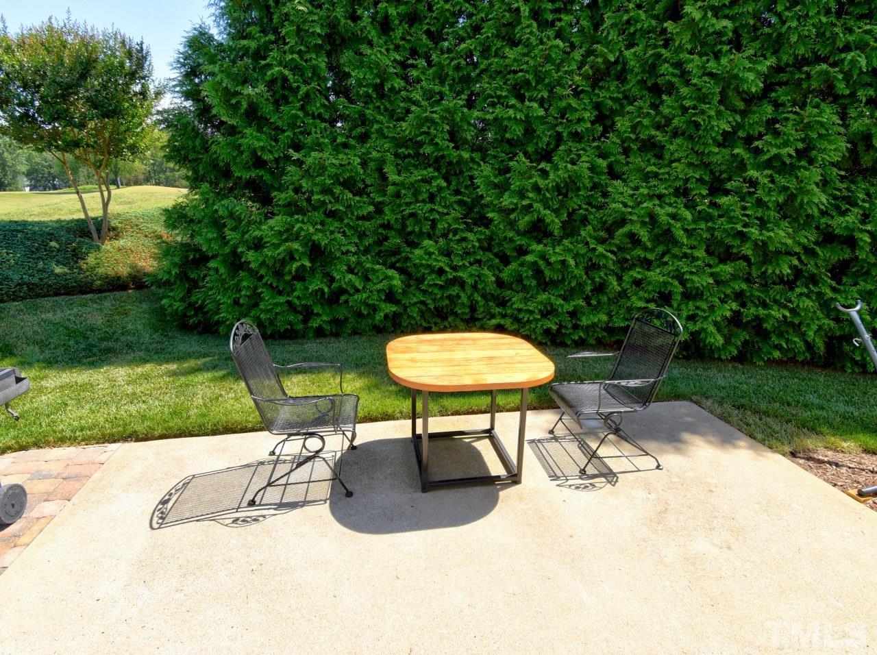 112 Poppy Hills Court Raleigh, NC 27603 - Photo 3 of 42 a view of a backyard with a table chairs and a slide