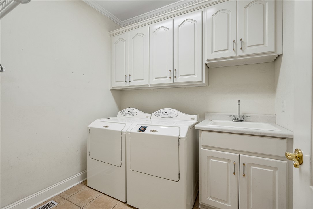 135 Sunset Bay Boulevard Seneca, SC 29672 - Photo 41 of 50 Functional utility room with ample storage and a convenient wash basin.