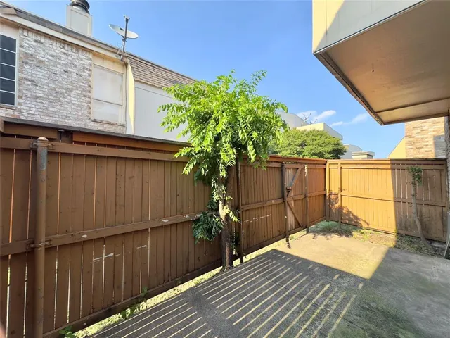 a view of a backyard with wooden fence
