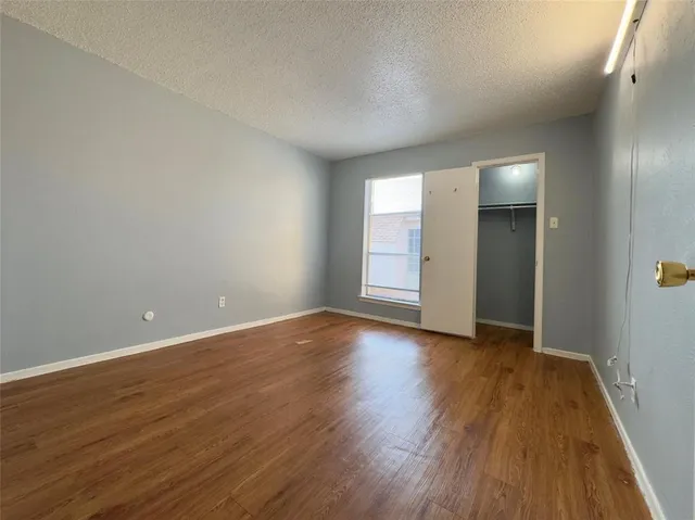 a view of an empty room and wooden floor