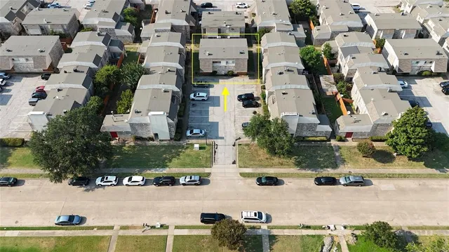 an aerial view of residential houses with outdoor space
