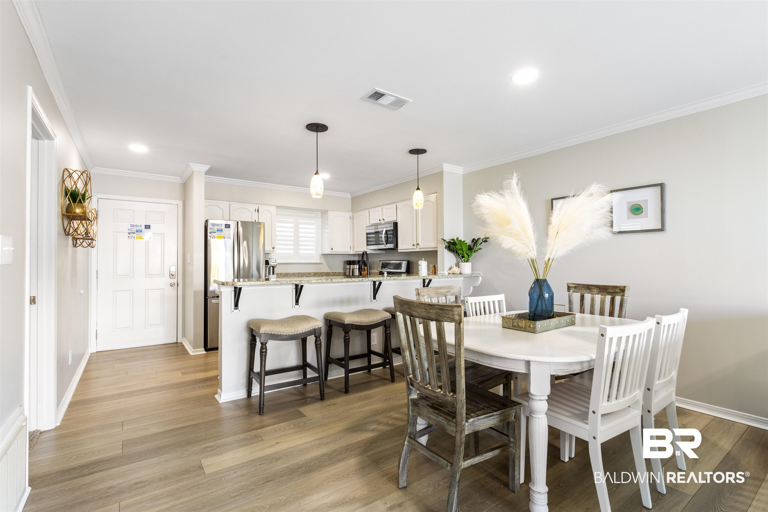 25861 Canal Road, Unit 3 Orange Beach, AL 36561 - Photo 10 of 40 Dining space featuring crown molding, light wood-type flooring, and recessed lighting