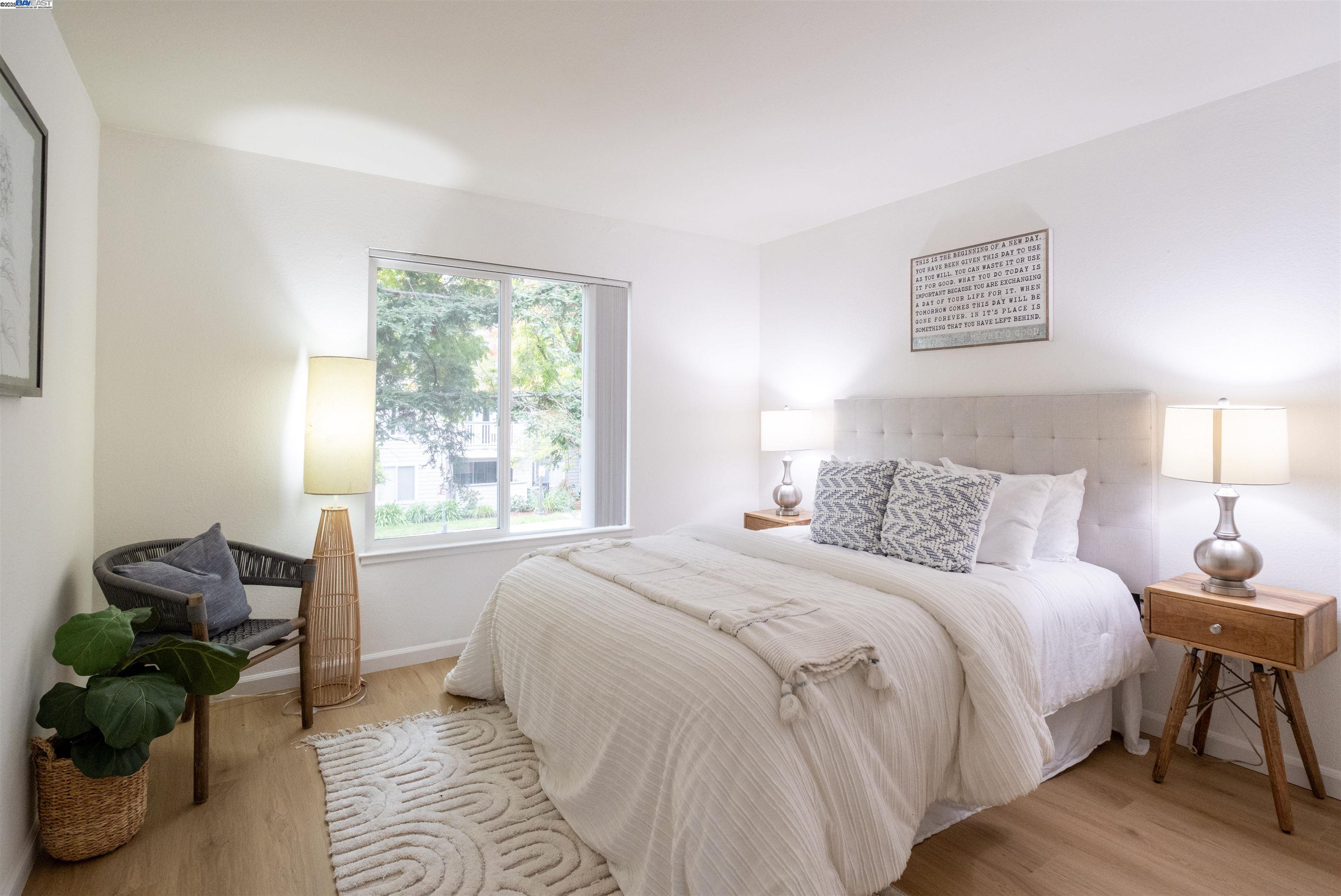 285 Reflections Drive, Unit 23 San Ramon, CA 94583 - Photo 13 of 33 a bedroom with a bed couches chair and a large window