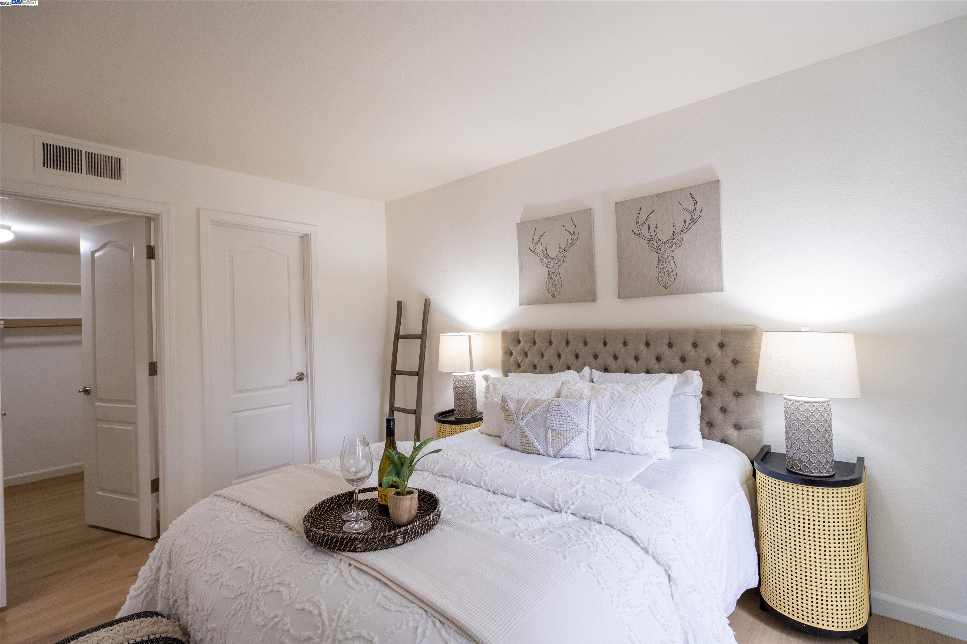 285 Reflections Drive, Unit 23 San Ramon, CA 94583 - Photo 14 of 33 a bedroom with a bed and lamp