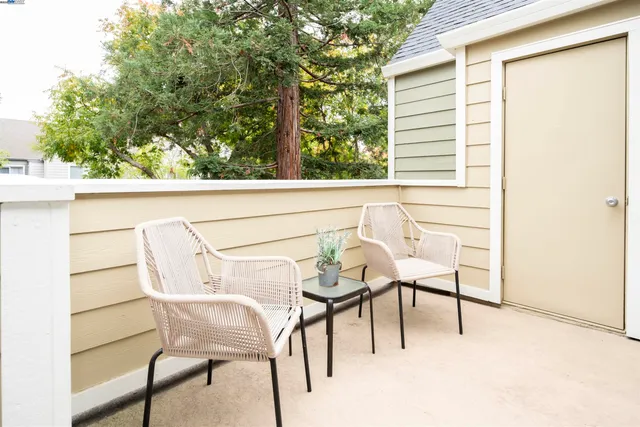 a view of a chairs and table in the balcony