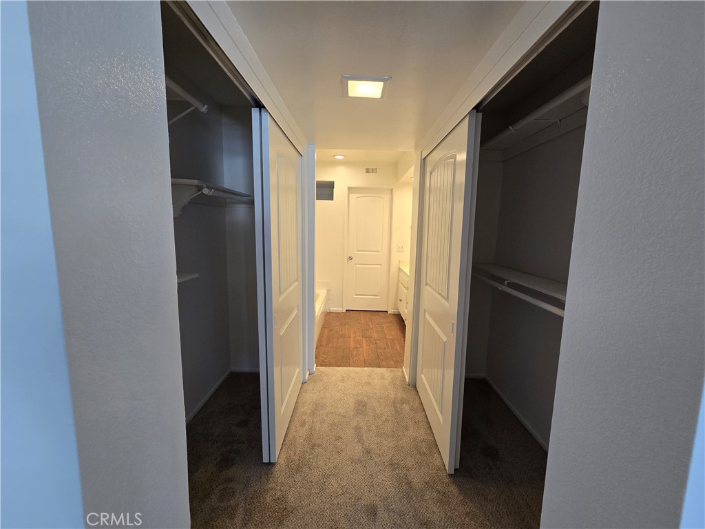 783 Grayling Costa Mesa, CA 92626 - Photo 14 of 25 a view of hallway with walk in closet and wooden floor