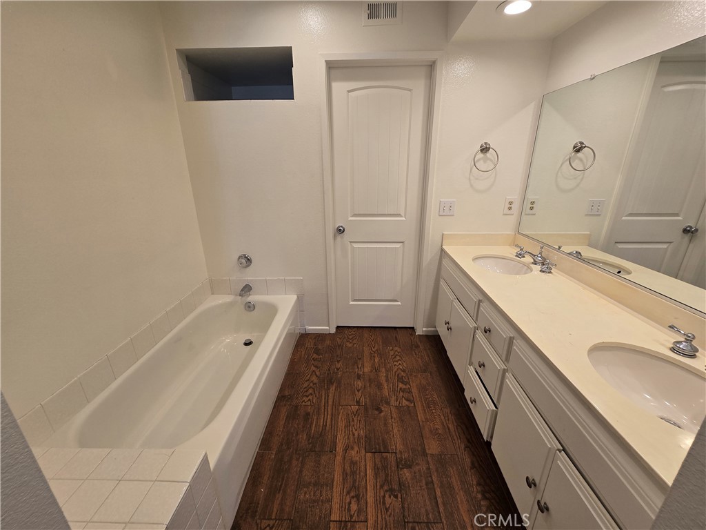 783 Grayling Costa Mesa, CA 92626 - Photo 15 of 25 a spacious bathroom with a granite countertop sink mirror and bathtub