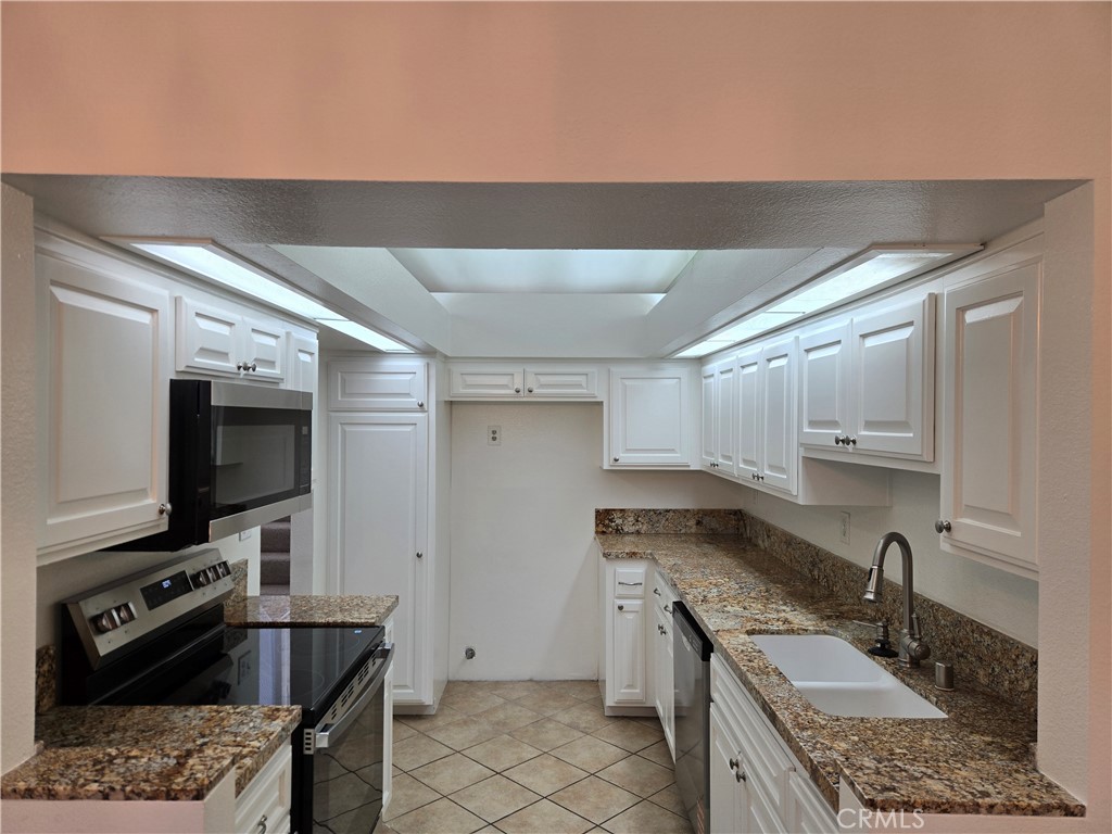 783 Grayling Costa Mesa, CA 92626 - Photo 3 of 25 a kitchen that has a sink and a stove in it