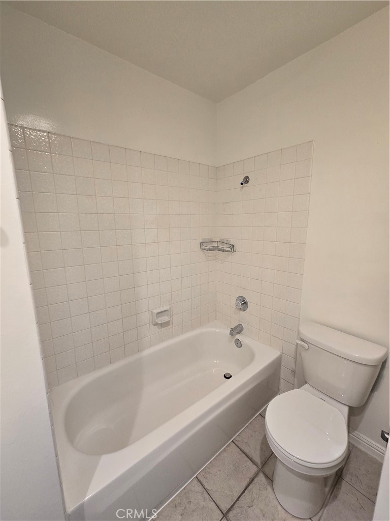 783 Grayling Costa Mesa, CA 92626 - Photo 10 of 25 a white bath tub sitting next to a white toilet and sink
