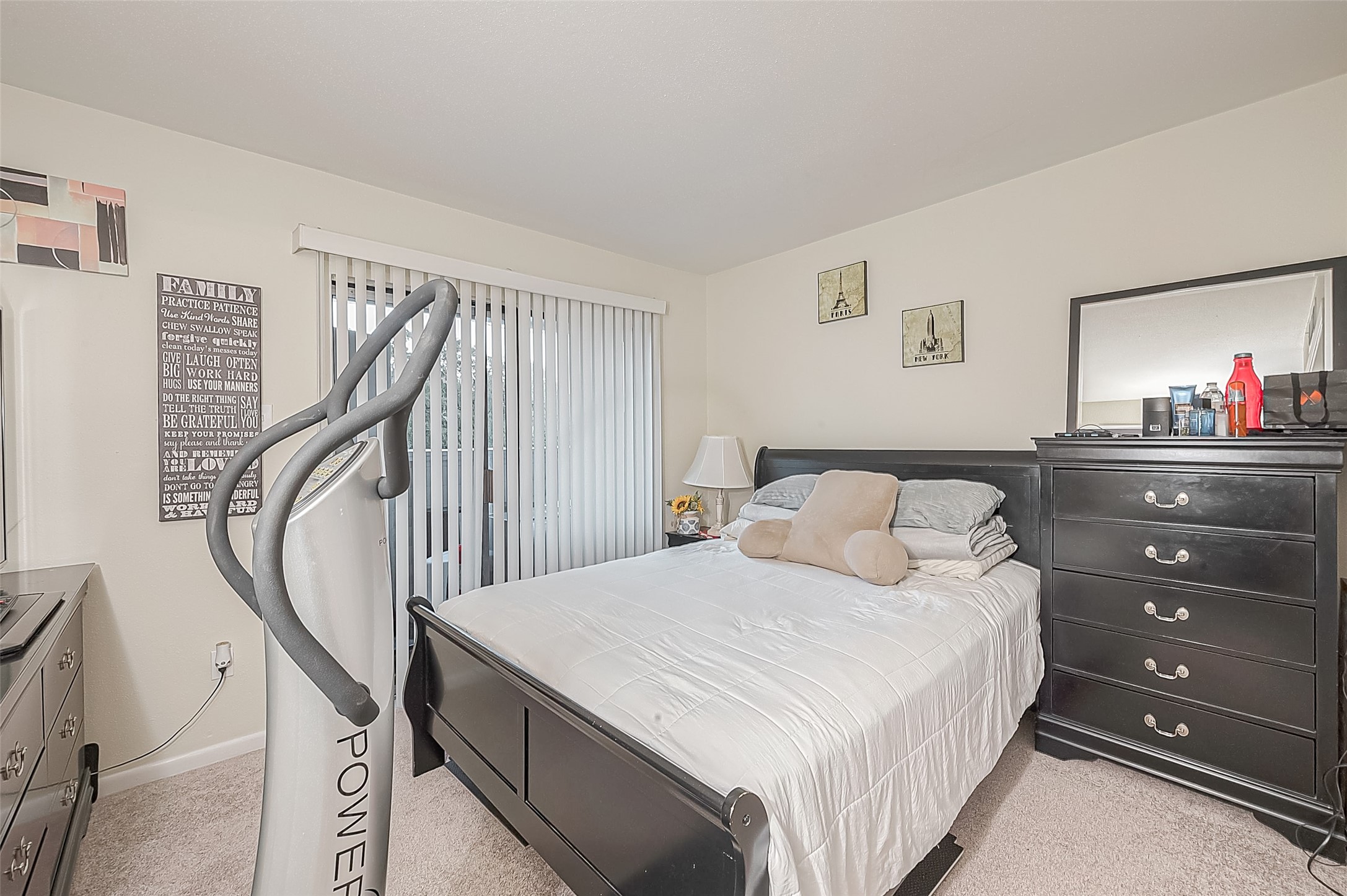 3075 Walnut Bend Lane, Unit 28 Houston, TX 77042 - Photo 14 of 19 a bedroom with a bed and a dresser with wooden floor