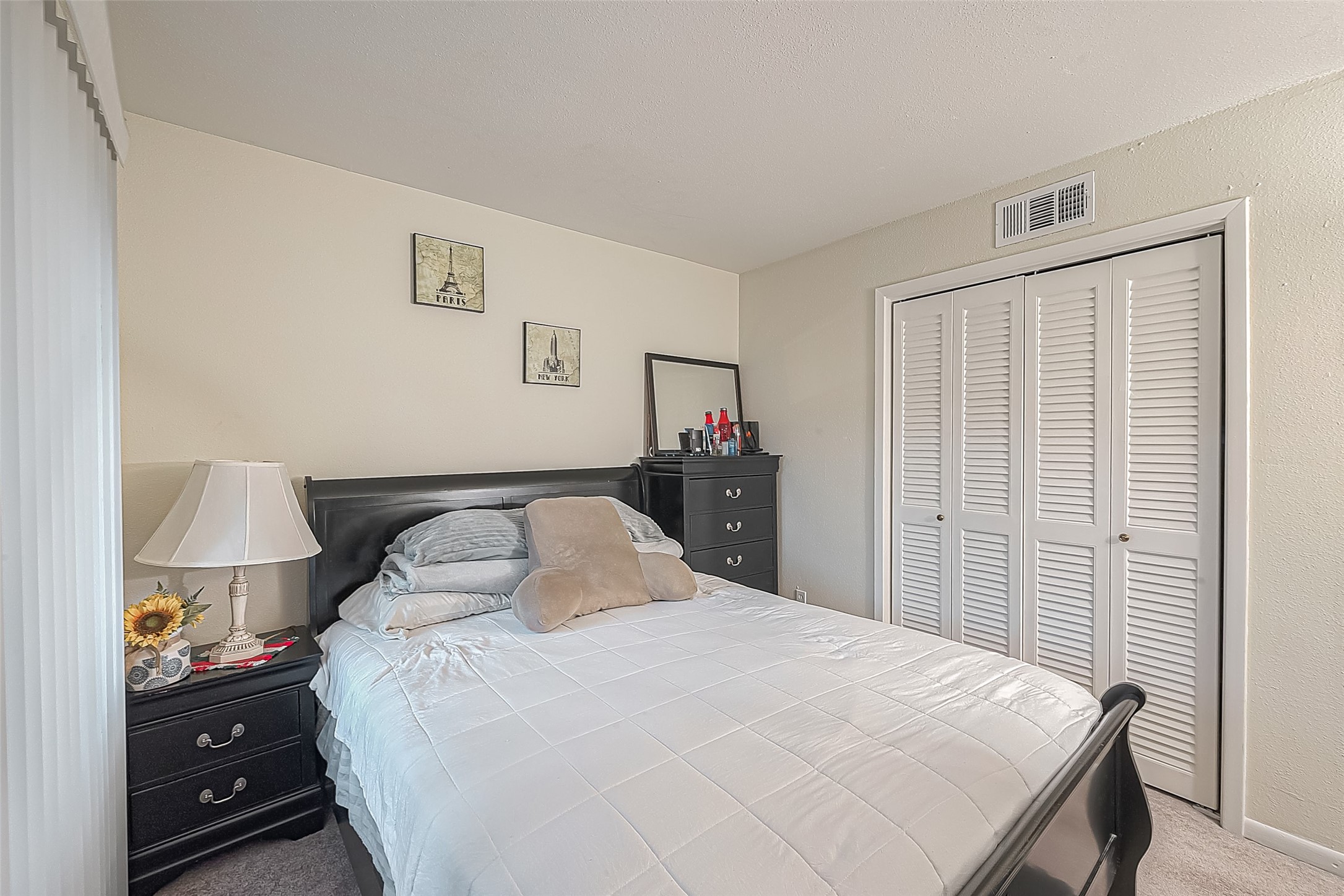 3075 Walnut Bend Lane, Unit 28 Houston, TX 77042 - Photo 16 of 19 a bedroom with a bed and a lamp on the dresser