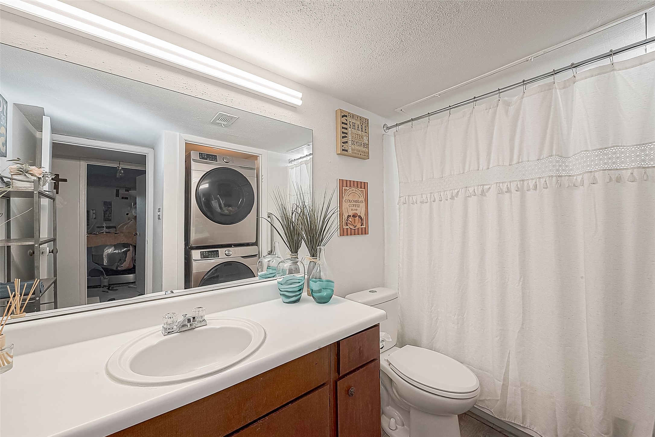 3075 Walnut Bend Lane, Unit 28 Houston, TX 77042 - Photo 6 of 19 a bathroom with a granite countertop sink vanity mirror and toilet