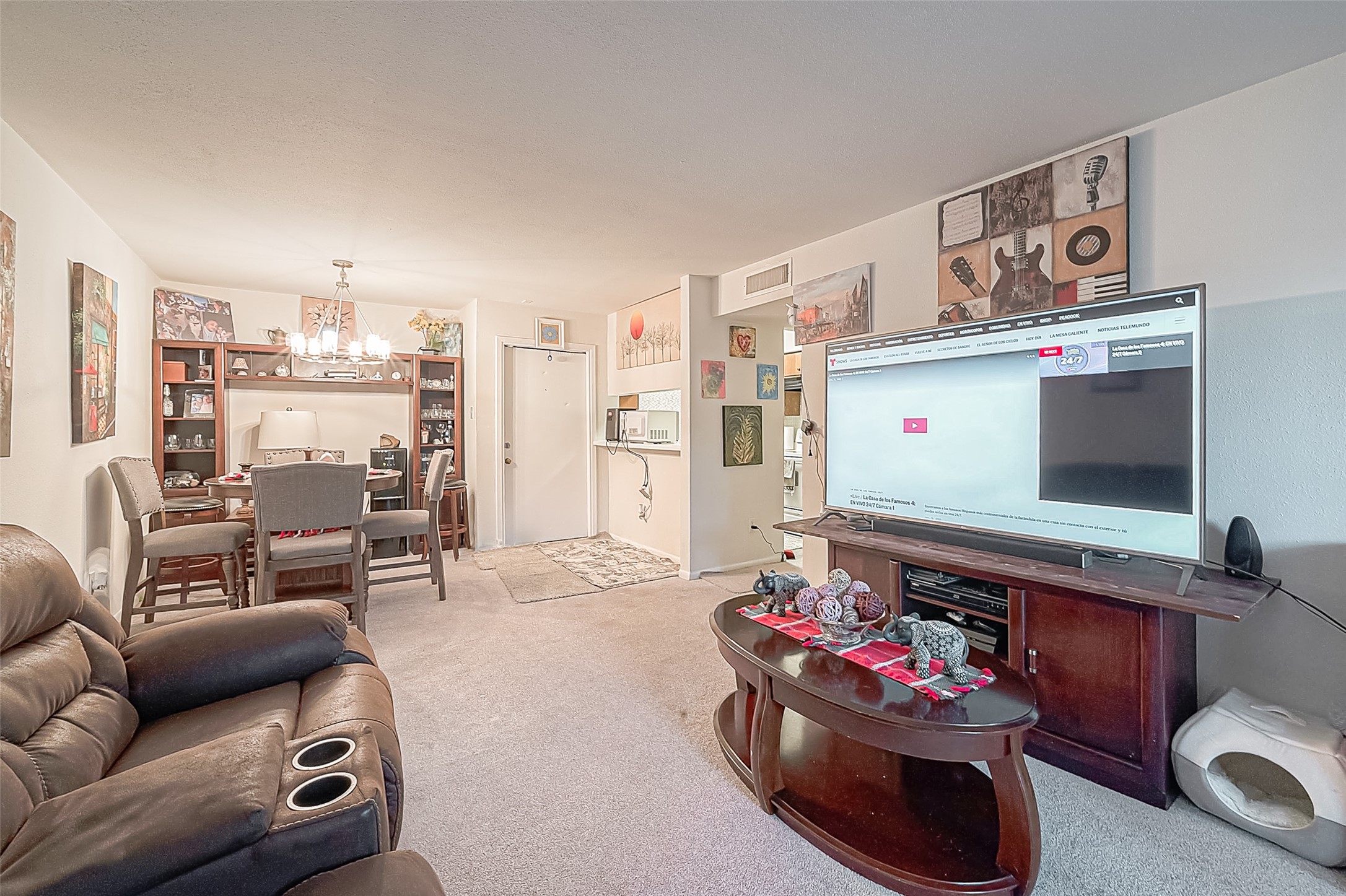 3075 Walnut Bend Lane, Unit 28 Houston, TX 77042 - Photo 9 of 19 a living room with furniture and a flat screen tv