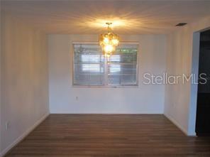 8928 Sterling Lane Port Richey, FL 34668 - Photo 3 of 6 a view of empty room with wooden floor