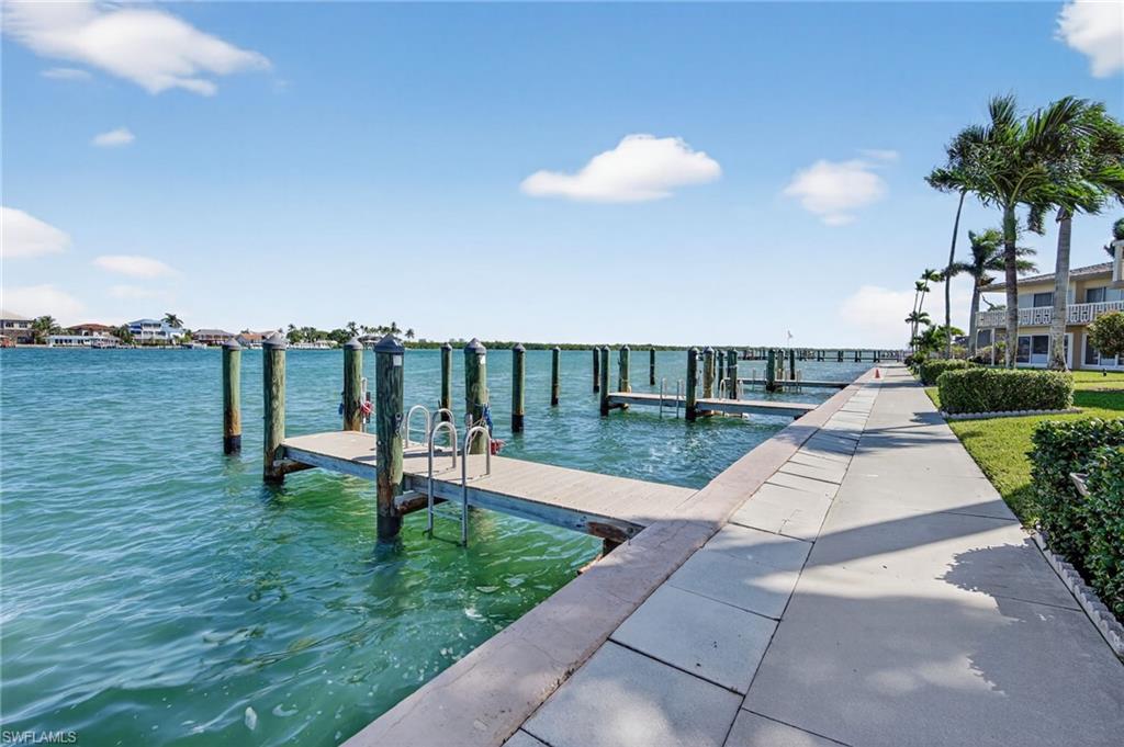 1215 Edington Place, Unit A2 Marco Island, FL 34145 - Photo 13 of 29 a view of a garden with a bench