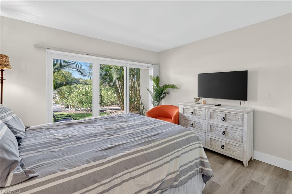 1215 Edington Place, Unit A2 Marco Island, FL 34145 - Photo 17 of 29 a bedroom with a bed and a flat screen tv