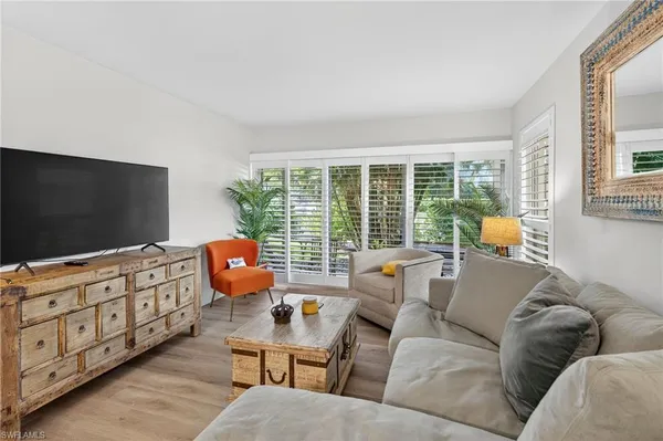 a living room with furniture cabinets and a flat screen tv
