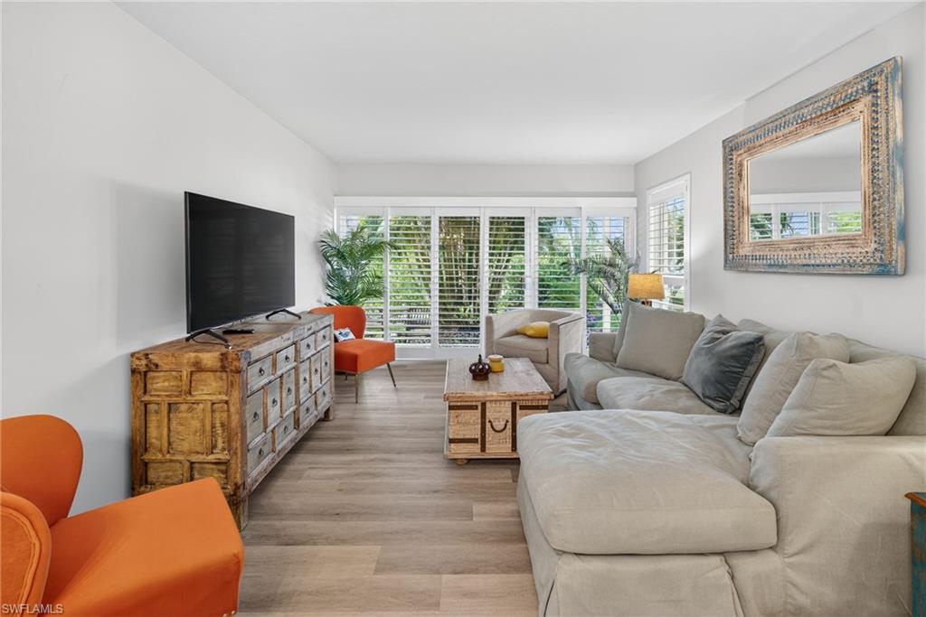 1215 Edington Place, Unit A2 Marco Island, FL 34145 - Photo 27 of 29 a living room with furniture and a flat screen tv